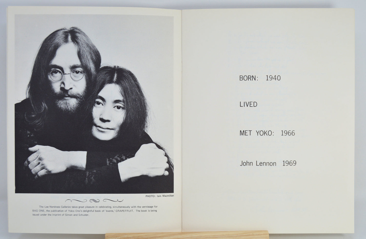 Book open to a page with a black and white photo of a couple and text about John Lennon meeting Yoko Ono.