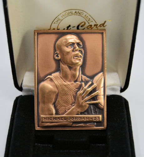 Bronze collectible card of a basketball player with 'Michael Jordan' and number '23' on a black background. Made by the Highland Mint.