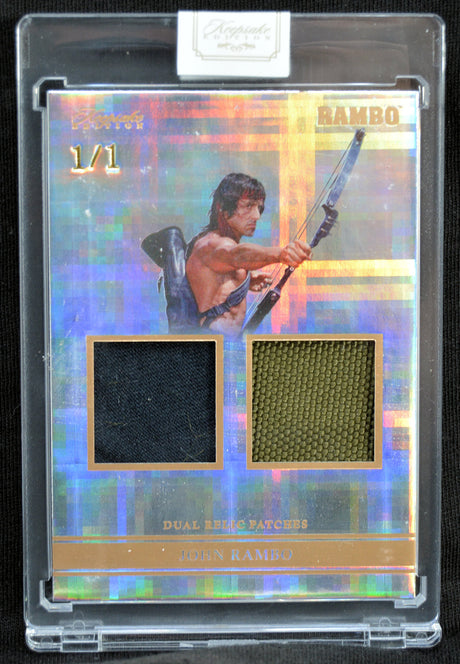 Trading card with a holographic border featuring John Rambo holding a weapon, with dual patch elements.