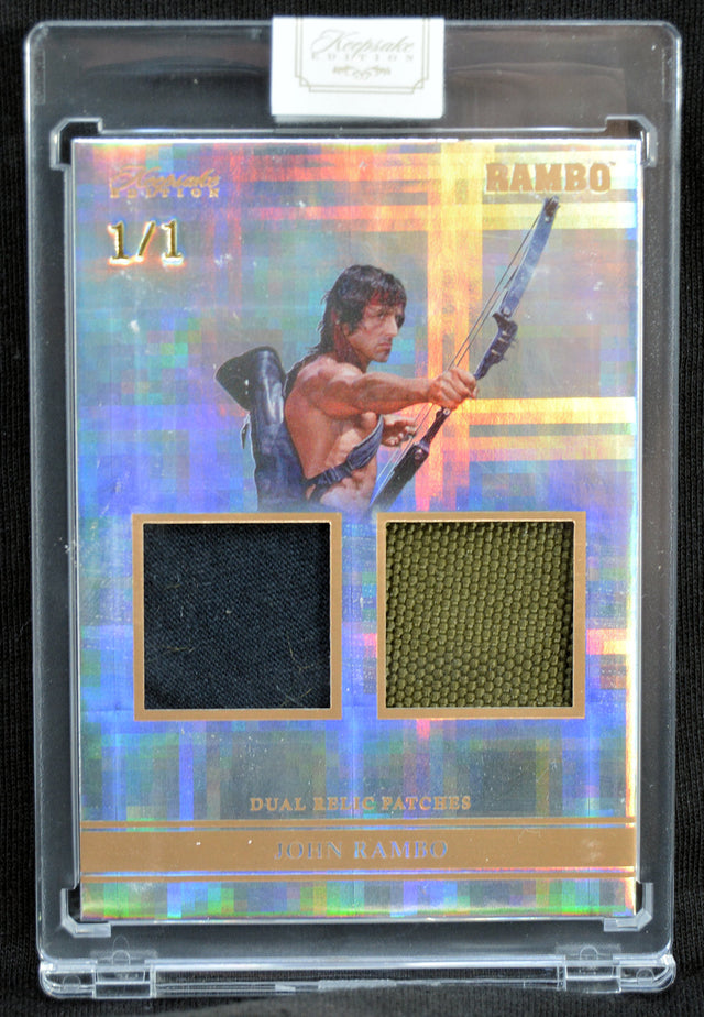 Trading card with a holographic border featuring John Rambo holding a weapon, with dual patch elements.