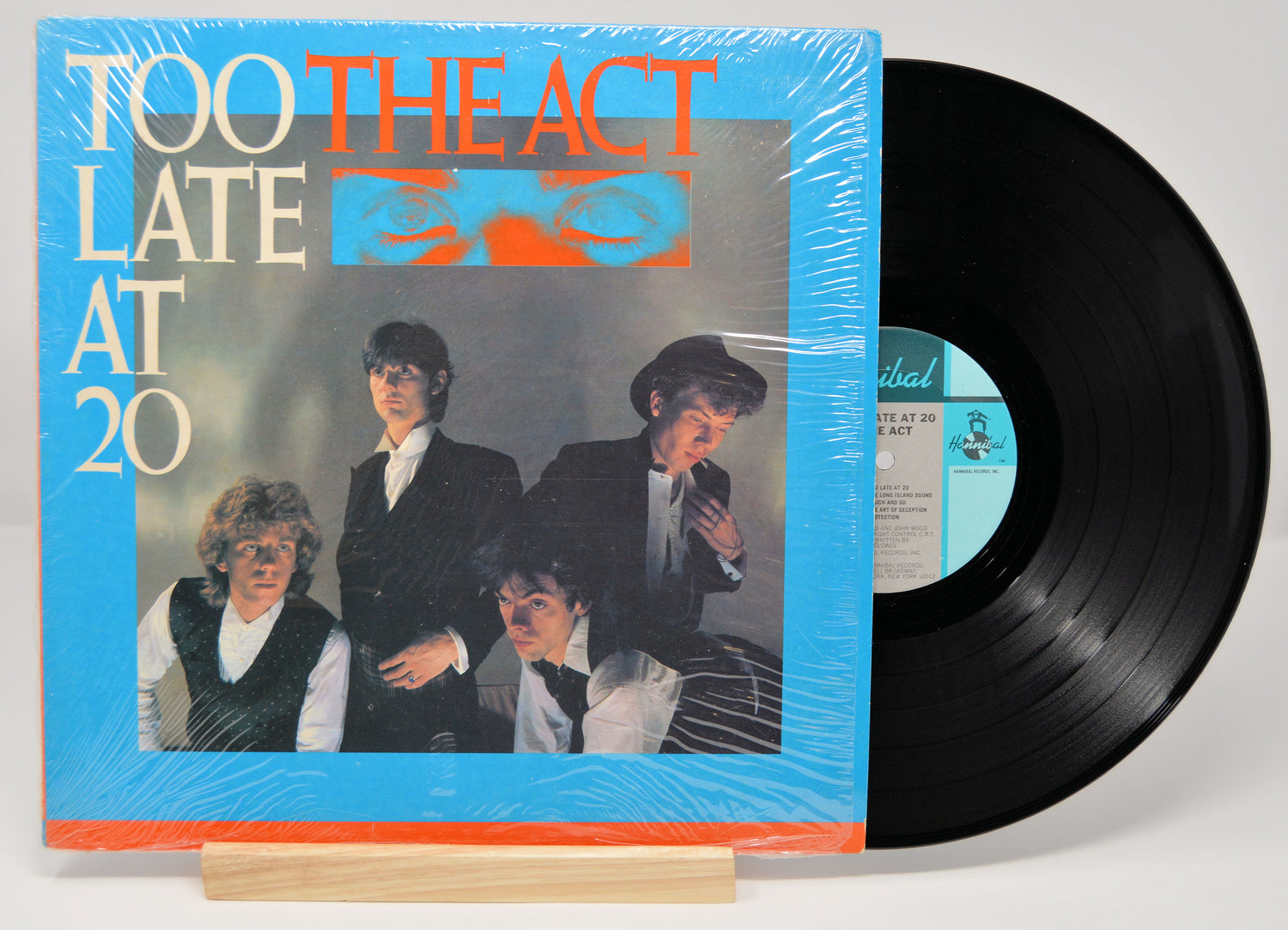 Vinyl record of The Act album 'Too Late At 20' with a blue and orange cover.