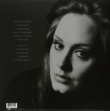 Black and white album cover of Adele with the title '21' in green text.