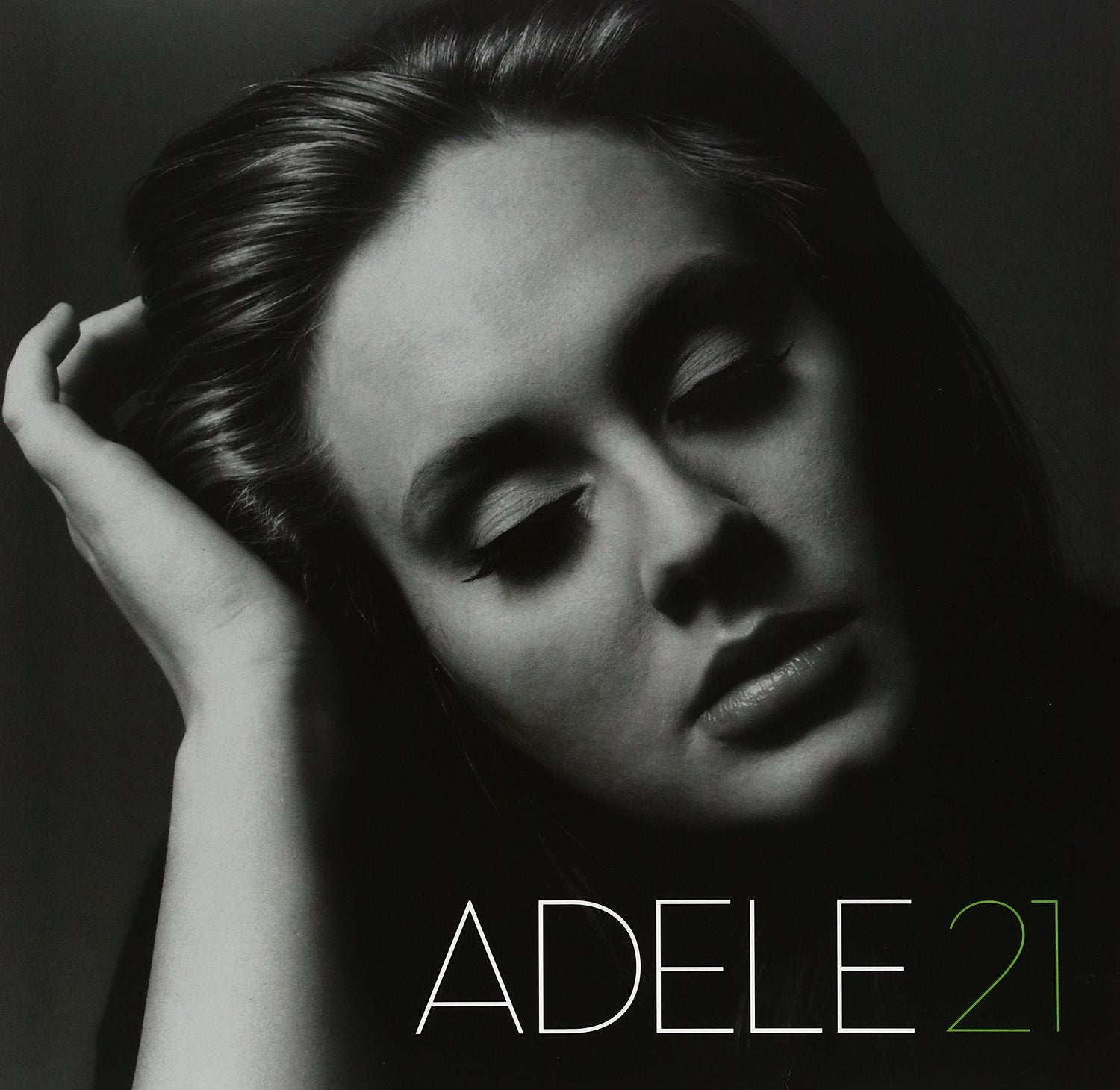 Black and white album cover of Adele with the title '21' in green text.