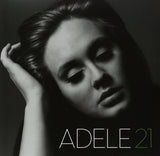Black and white album cover of Adele with the title '21' in green text.