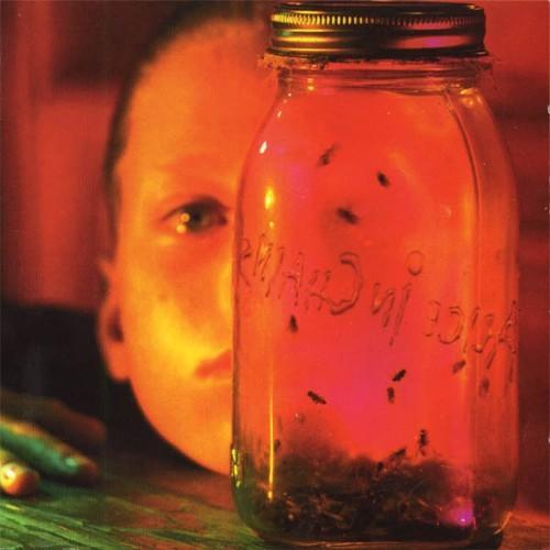Album cover of Alice In Chains - Jar Of Flies featuring a glass jar with insects inside and a child's face in the background.