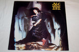 Vinyl record album cover featuring a monochrome image of a woman in an dramatic pose with flowing fabrics around her.