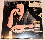 vinyl record cover featuring artwork of a man sitting at a table