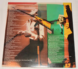 Used vinyl record of Peter Allen's album 'Taught By Experts' with a colorful cover featuring a portrait of the artist and silhouettes of hands.