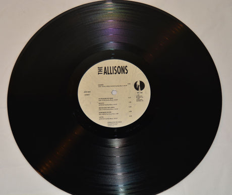 A vinyl record of The Allisons with a label that includes tracklisting and the band's name.