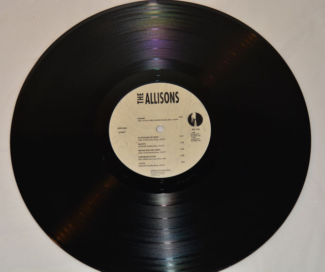 A vinyl record of The Allisons with a label that includes tracklisting and the band's name.