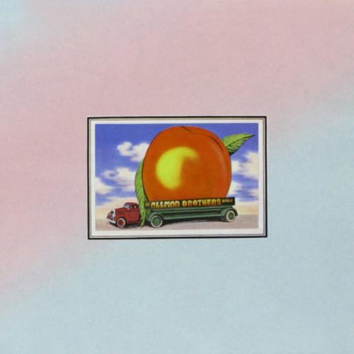 Album cover art for 'Eat A Peach' by the Allman Brothers featuring a large peach with a small school bus in front, set against a blue sky background.