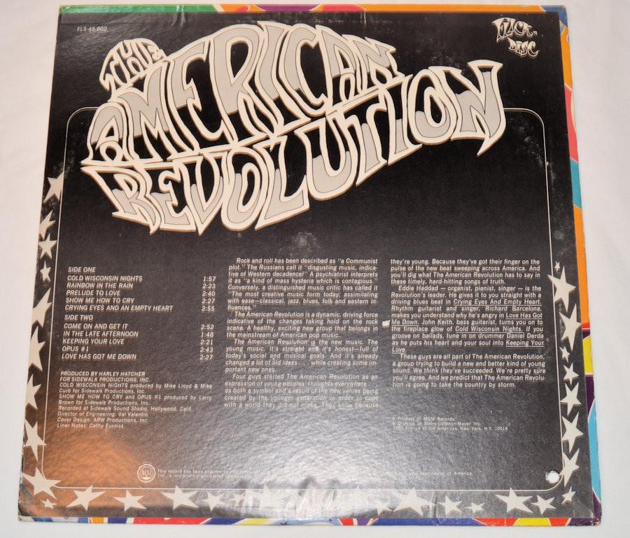 Used vinyl record album cover for 'American Revolution' by The American Revolution featuring colorful artwork with the band's name and faces.