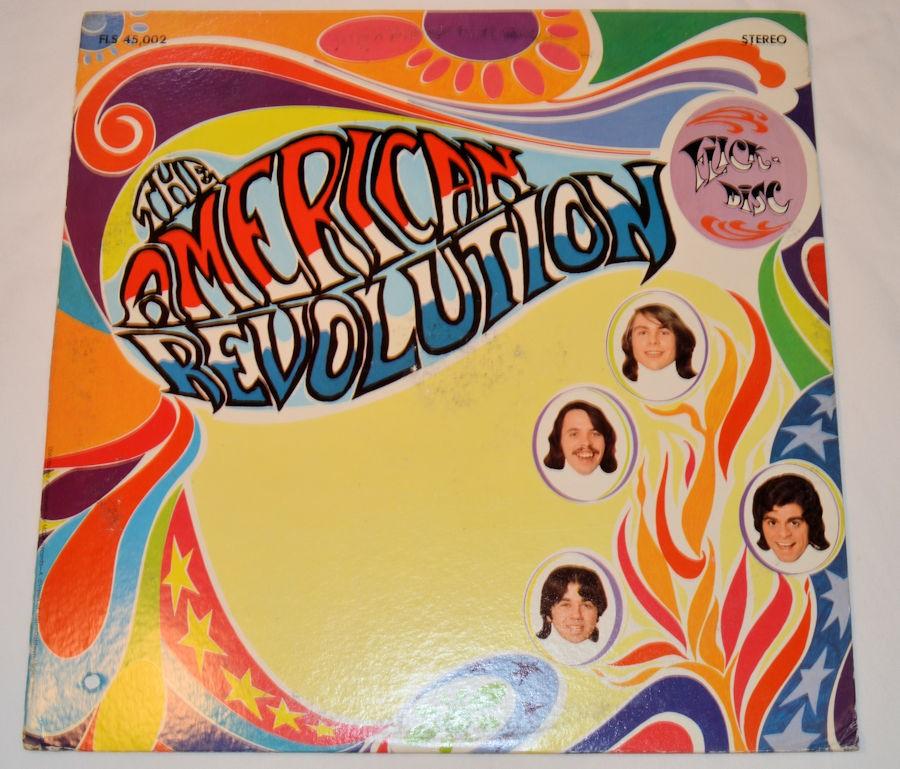 Used vinyl record album cover for 'American Revolution' by The American Revolution featuring colorful artwork with the band's name and faces.