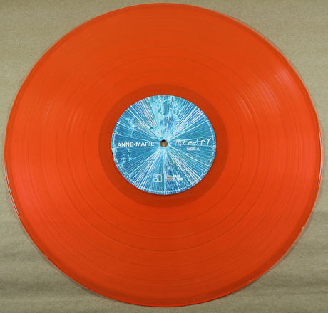 orange vinyl record featuring Anne-Marie