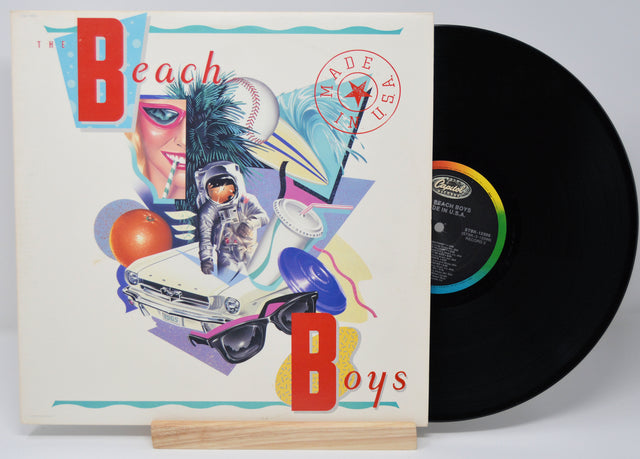 Beach Boys album 'Made in The USA' vinyl record with cover art featuring the band members, a convertible car, and the text 'Made in The USA'.