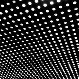 Close-up view of a vinyl record with a focus on the grooves and a dimly lit background.