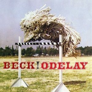 The image shows the cover art for the vinyl record 'Beck - Odelay.' It features a black and white photo of a man jumping over a hurdle, with the album title 'Odelay' and the artist's name 'Beck' prominently displayed.