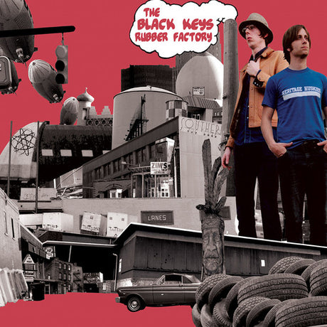 Album cover art for The Black Keys' Rubber Factory featuring a black and white photograph of an industrial setting with tires and factory buildings, alongside portraits of the band members.