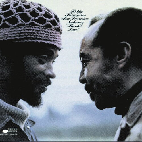 Album cover with two people facing each other, featuring text and a logo.