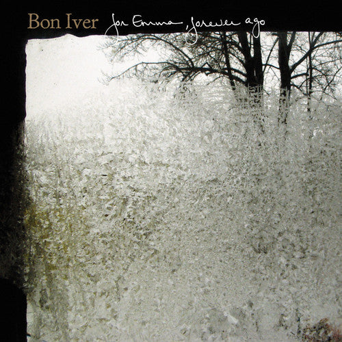 This image features the album cover for "Bon Iver - From Emma Forever," a new vinyl record. The cover art is strikingly atmospheric, showcasing a blurred, misty view of a forest through a window, with the artist's name and the album title elegantly scripted at the top.