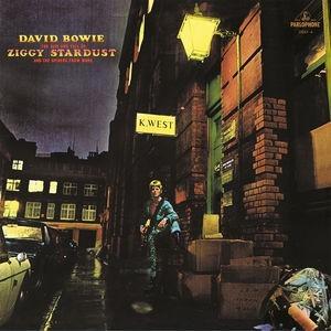 David Bowie album cover for 'The Rise And Fall Of Ziggy Stardust And Spiders From Mars' featuring an image of David Bowie walking down a city street at night.