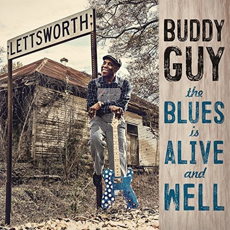 Album cover with a person holding a guitar, a signpost, and text about Buddy Guy's album 'The Blues is Alive and Well'.