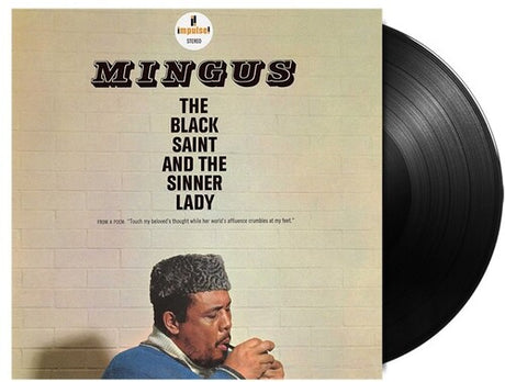 Vinyl record with cover featuring a man and text 'Mingus: The Black Saint and the Sinner Lady' on a beige background.