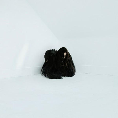 A vinyl record of Chelsea Wolfe's album 'Hiss Spun' with a red clear color variant, displayed on a white background.