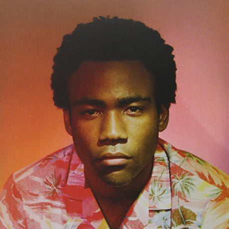 Childish Gambino wearing a multicolored shirt, posing for a photo.