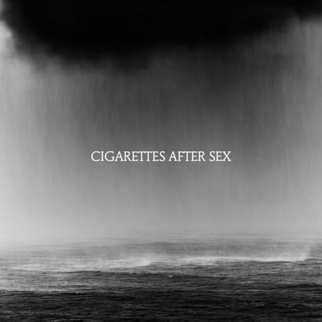 Black and white album cover featuring a misty sea landscape with the band's name 'Cigarettes After Sex' displayed prominently.