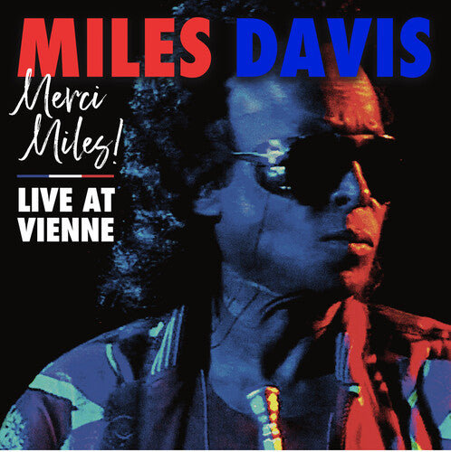 cover featuring Miles Davis in large aviator style sunglasses with a blue and orange lighting hue 
