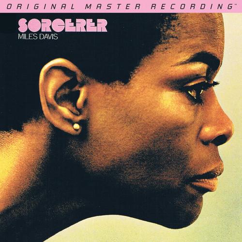 Cover art for the vinyl record 'Sorcerer' by Miles Davis, featuring a portrait of the artist with a yellow tint and subtle background.