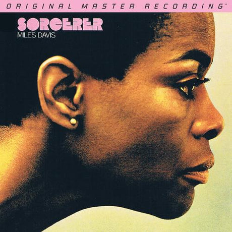 Cover art for the vinyl record 'Sorcerer' by Miles Davis, featuring a portrait of the artist with a yellow tint and subtle background.
