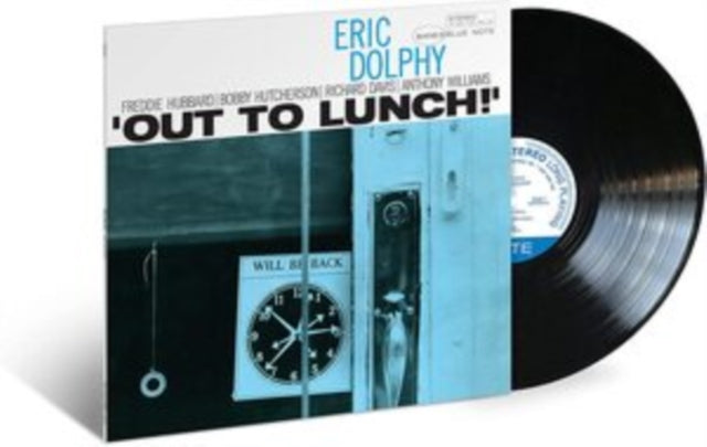 A vinyl record of Eric Dolphy's album 'Out To Lunch' with a blue and black cover, featuring images of a clock and a door.