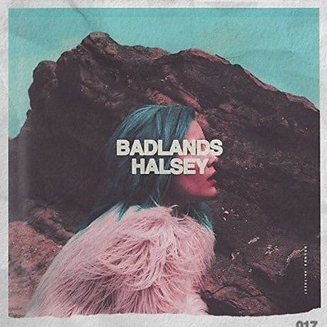 This image features the album cover of "Badlands" by Halsey, a vinyl record representing the artist's debut full-length album. The cover art depicts a enigmatic scene with Halsey partially concealed by a rock formation, adding a sense of mystery and depth.