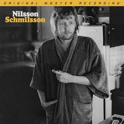 Album cover with a person in a robe standing in a kitchen, featuring 'Nilsson Schmilsson' text.