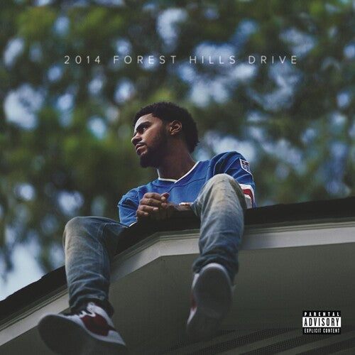 A vinyl record album cover featuring J. Cole sitting on a rooftop with a tree in the background.