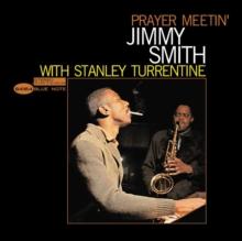 Album cover for 'Prayer Meetin' with Jimmy Smith and Stanley Turrentine' featuring a black background, yellow title text, and a central photo of the musicians performing.