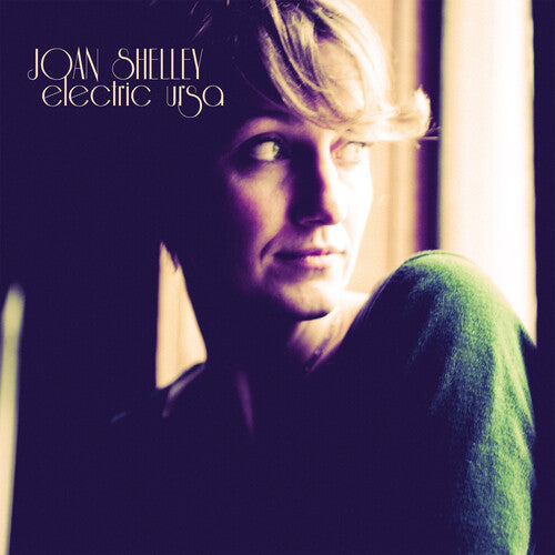 Album cover with a person wearing a green sweater, text 'Joan Shelley Electric Ursa' on a dark background.