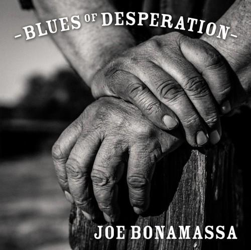 Album cover with hands clasped together and text 'Blues of Desperation' by Joe Bonamassa.