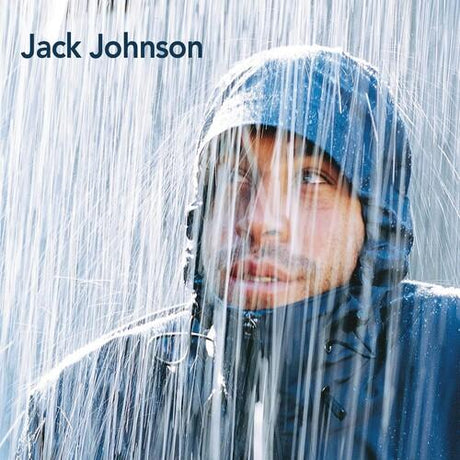 A person wearing a hooded jacket with raindrops on it, set against a grey background.