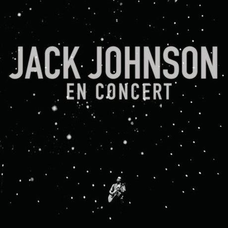 Vinyl record album cover for Johnson, Jack - En Concert, featuring a black background with white snowflakes and the artist's silhouette playing a guitar.