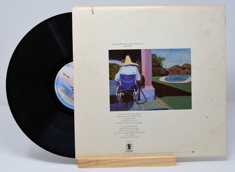Vinyl record by Joni Mitchell titled 'Mingus' along with the back cover which includes the song titles in text and a drawing of someone in wheelchair.