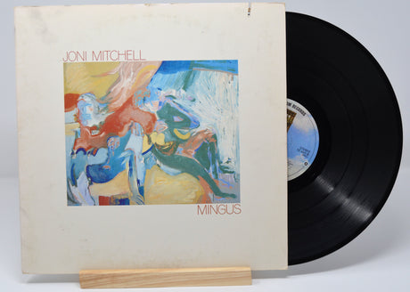 Vinyl record of Joni Mitchell's album 'Mingus' with a colorful abstract painting on the cover.
