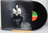 Vinyl record with cover featuring a person sitting on a stool, brand 'Julian Lennon' visible