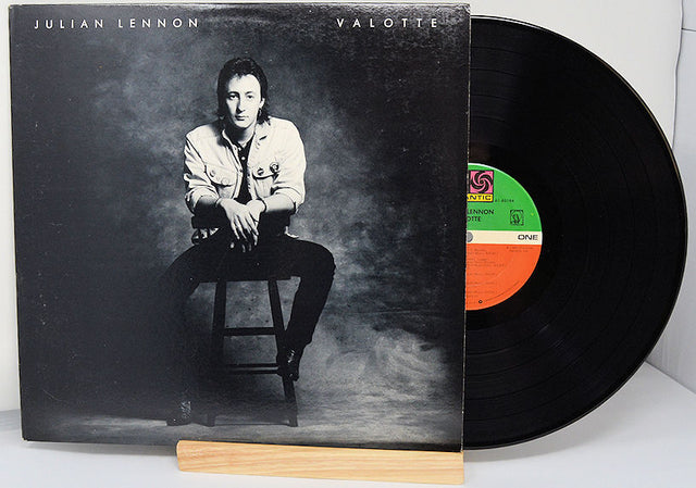 Vinyl record with cover featuring a person sitting on a stool, brand 'Julian Lennon' visible