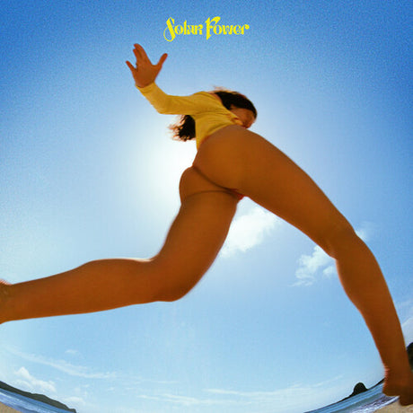 A vinyl record cover featuring the artist Lorde with the title 'Solar Power' prominently displayed, against a blue sky and ocean background.