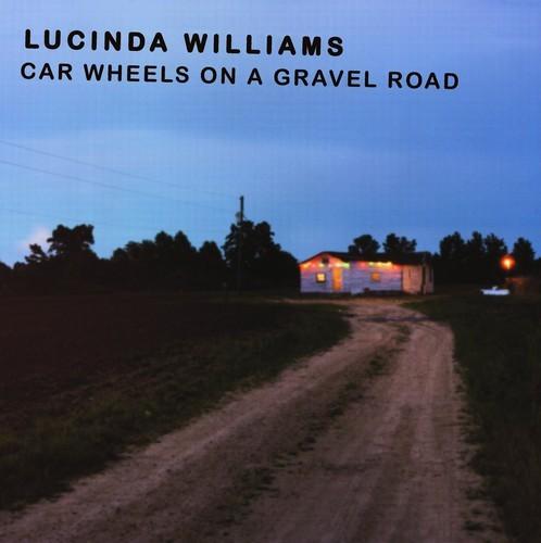Album cover with a dirt road leading to a building at dusk, featuring the text 'Lucinda Williams Car Wheels on a Gravel Road'.