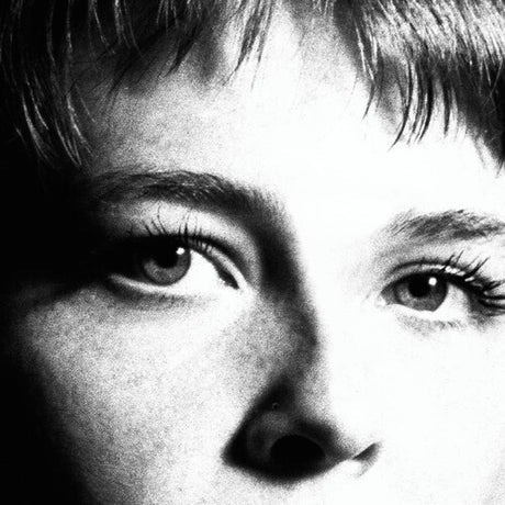 Black and white album cover featuring a close-up of a person's eyes, presumably the artist Maggie Rogers.