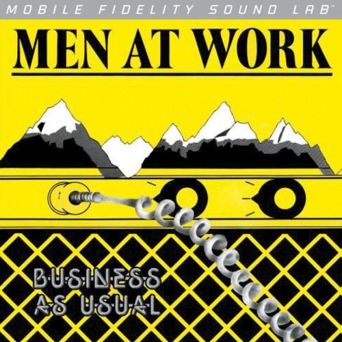 Album cover for 'Men at Work' with mountains and amplifier graphic on yellow background
